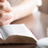 clasped-hands-open-bible-1200.png