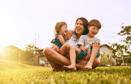 mother-children-laughing-grass-1200.png