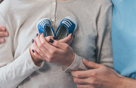 mother-holding-infant-shoes-1200.png