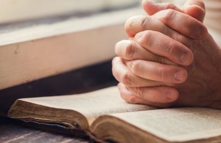 praying-hands-open-bible-desk-1200.png