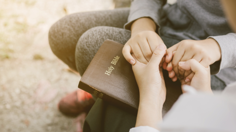 bible-holding-hands-1200.png