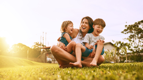 mother-children-laughing-grass-1200.png