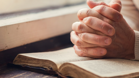 praying-hands-open-bible-desk-1200.png