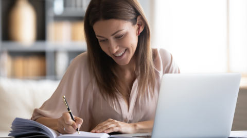 smiling-woman-taking-notes-1200.png